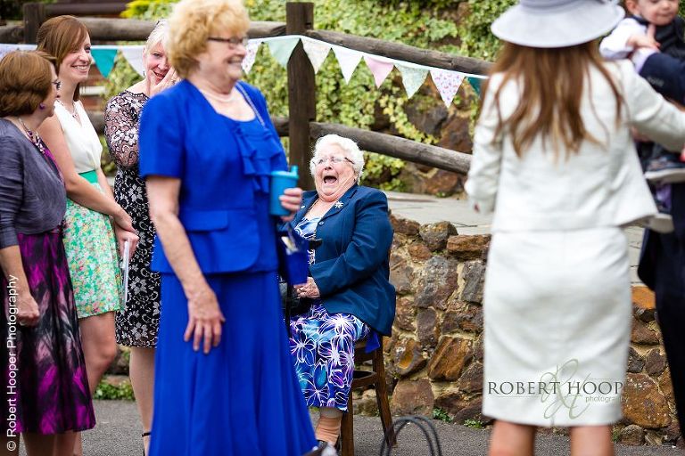 Wedding guests enjoying themselves at wedding at Coltsford Mill, Oxted in Surrey