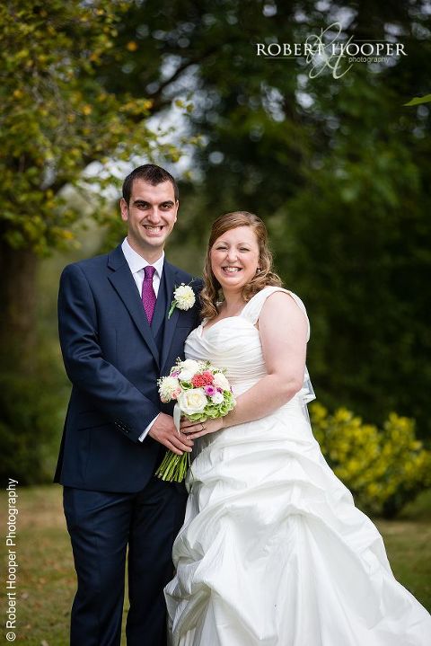 Bride and groom in the gardens at Coltsford Mill, Oxted in Surrey