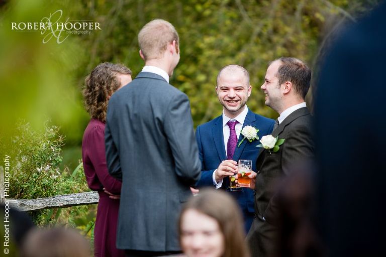 Guests drinking Pimms at drinks reception at Coltsford Mill, Oxted in Surrey