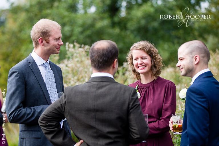 Guests at drinks reception after wedding at Coltsford Mill, Oxted in Surrey
