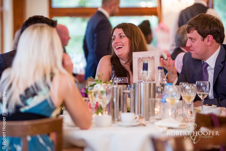 Wedding guests enjoying meal after wedding at Coltsford Mill, Oxted in Surrey