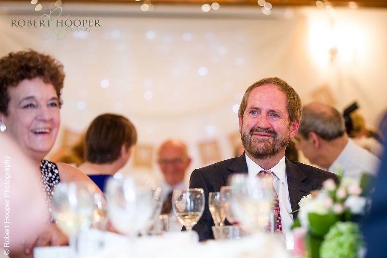 Wedding guests during speeches at wedding breakfast at Coltsford Mill, Oxted in Surrey