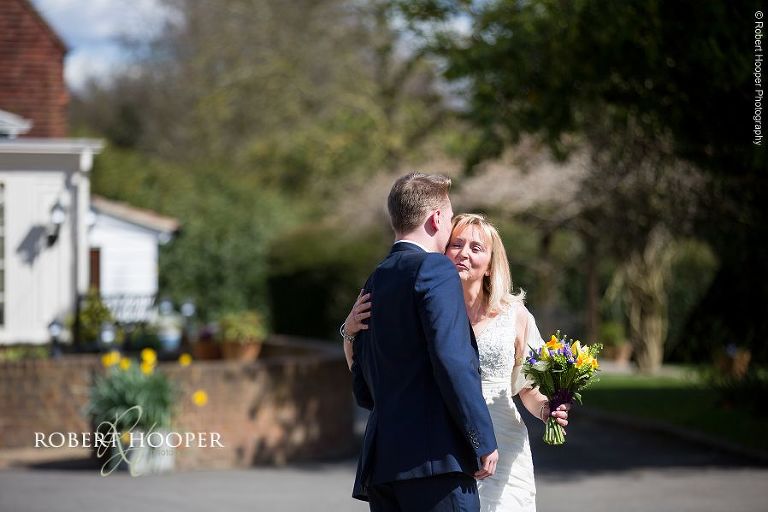 Son greets mum before wedding to give her away at Oaks Farm Barn in Surrey