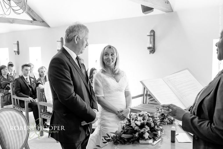 Bride and groom say their wedding vows during civil ceremony at Oaks Farm Barn, Surrey