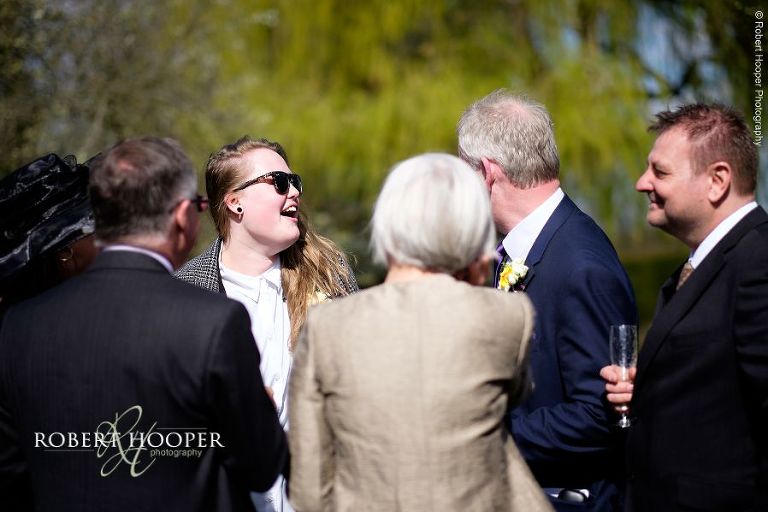 Wedding guests mingling and enjoying drinks reception at Oaks Farm Barn in Surrey