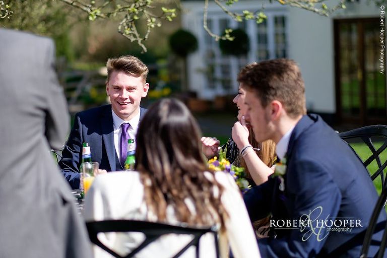 Wedding guests at drinks reception on wedding day at Oaks Farm Barn in Surrey