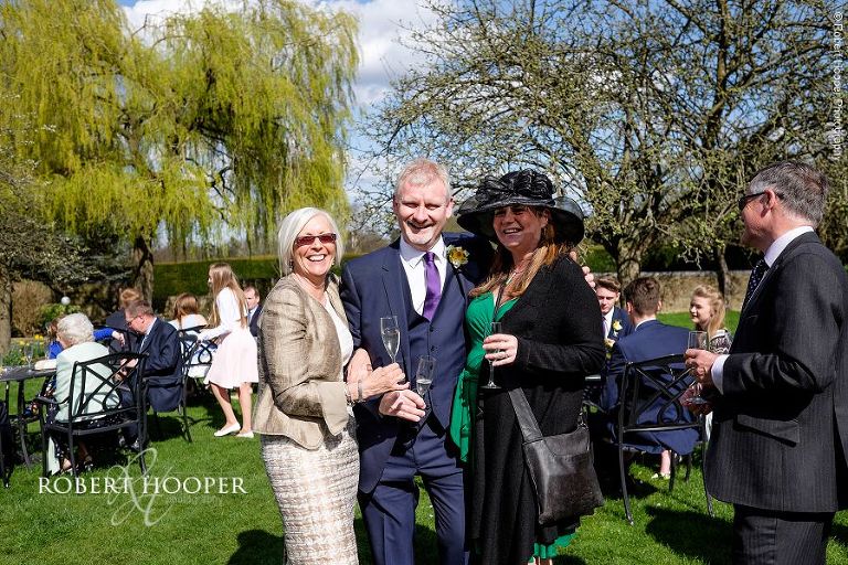 Groom and friends at drinks reception at Oaks Farm Barn in Surrey