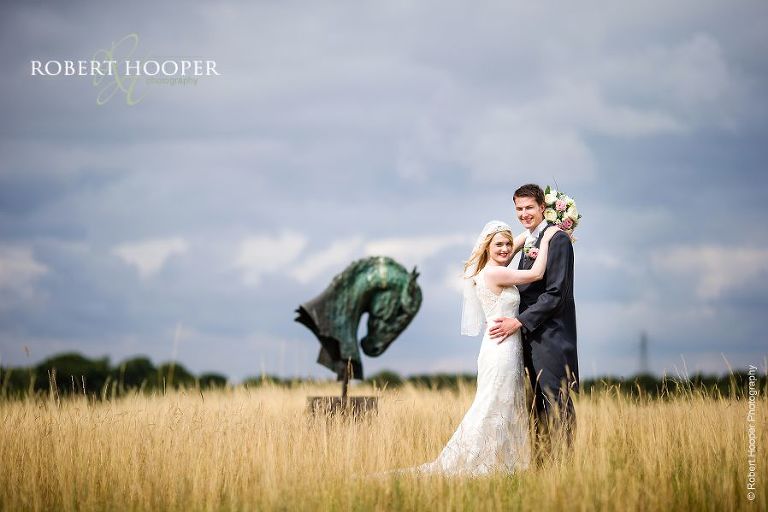 Bride and groom amid long grass at the London Golf Club on their wedding day