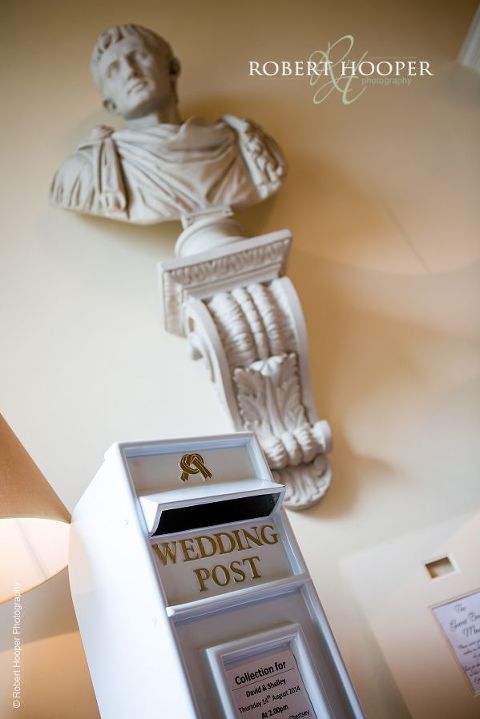 Wedding post box for cards with wall bust in background at Botleys Mansion in Chertsey, Surrey