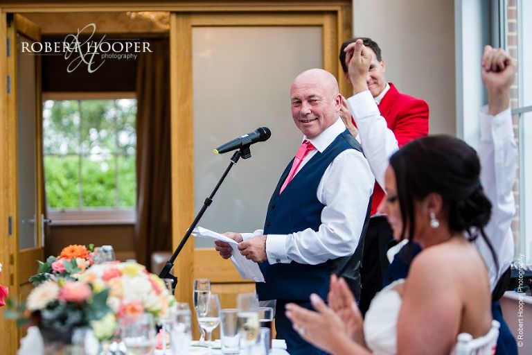 Father of the bride gives his speech in the glass atrium at Botleys Mansion, Chertsey in Surrey