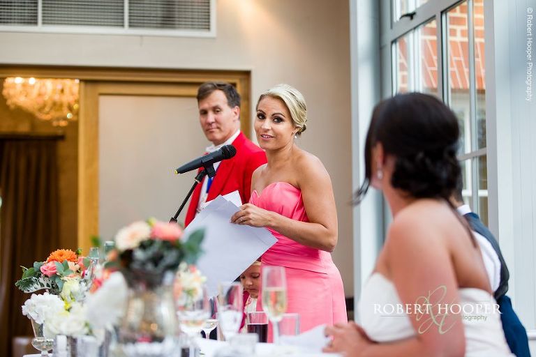 Bridesmaid giving a speech at summer wedding in the glass atrium at Botleys Mansion Surrey
