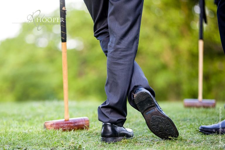 Wedding guest's shoes leaving on croquet stick during game of croquet at wedding reception at Botleys Mansion Surrey