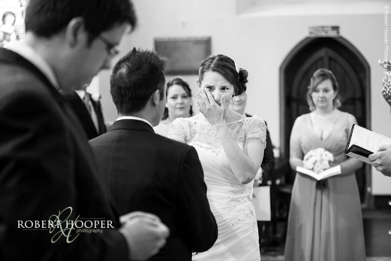 Bride sheds a tear during her marriage vows on wedding day at St.Anne's Church Surrey