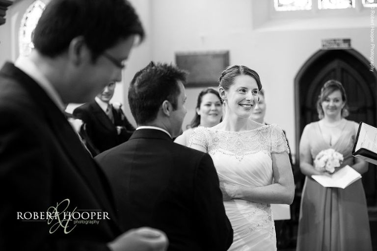 Smiles from the bride and groom during their marriage ceremony at St. Anne's Church Surrey