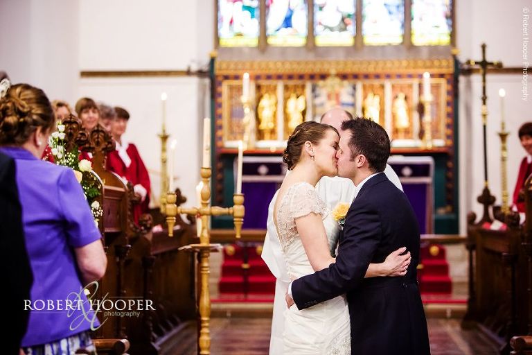 "You may kiss the bride" Bride and bride groom are pronounced man and wife on their wedding day at St. Anne's Church and Farnham Castle Surrey