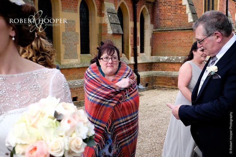 Guest wrapped in wooly blanket on chilly wedding day at St. Anne's Church Surrey