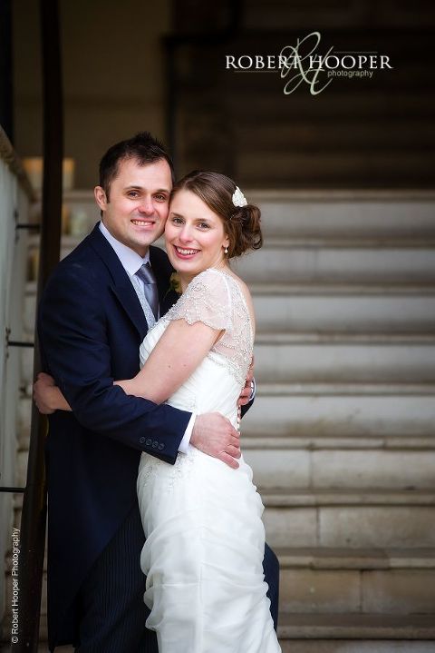 Bride and groom on wedding day at the entrance to Farnham Castle Surrey