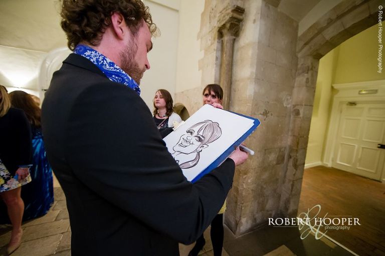 Artist drawing caricatures of wedding guests at Farnham Castle Surrey