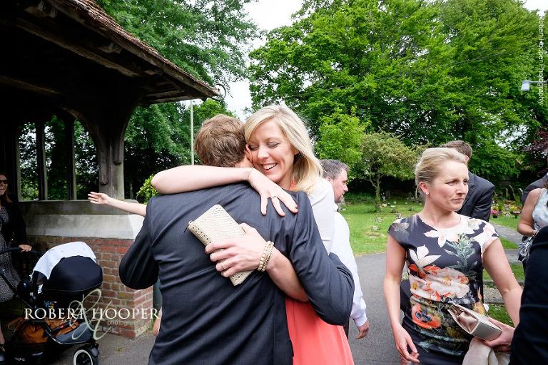 Wedding guests greeting each other at All Saints' Hordle Church Lymington Hampshire