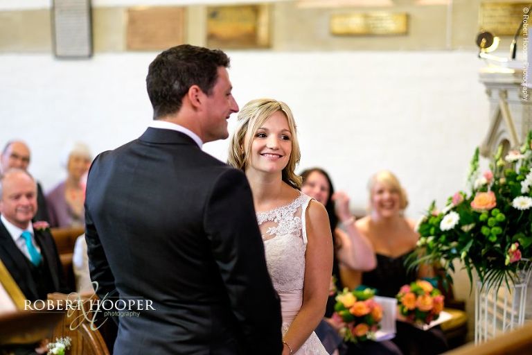 Bride and bride groom saying their vows on their wedding day at All Saints' Church Hordle Hampshire