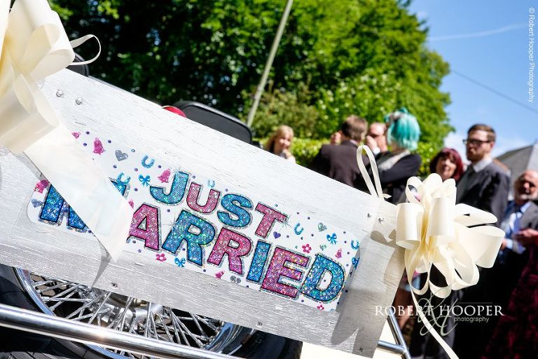"Just Married" sign on back of vintage wedding car driven by bride and groom after their ceremony to wedding reception at the Three Tuns in Dorset