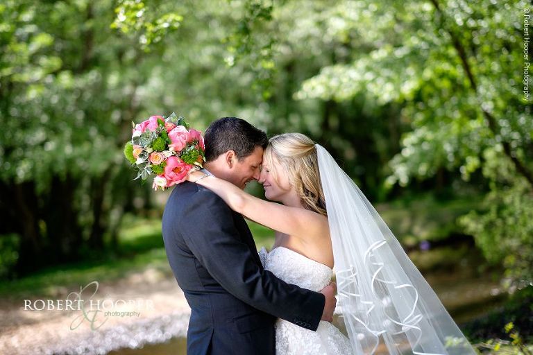Bride and groom embrace for informal pictures of them together after their marriage at All Saints Hordle in Hampshire