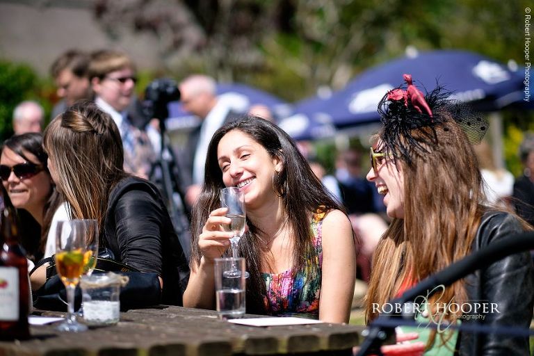 Wedding guests enjoying champagne and sunshine at garden wedding reception at The Three Tuns Bransgore, Dorset