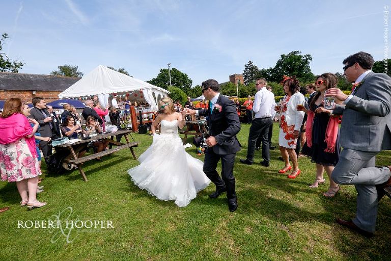 Bride and groom dancing together in sunglasses to the music of the string wedding band at their wedding celebration in the gardens of The Three Tuns Bransgore Dorset