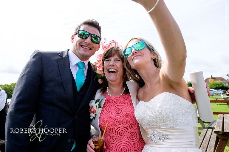 Bride ,groom and mother of the bride taking selfie on wedding day at The Three Tuns Bransgore Dorset