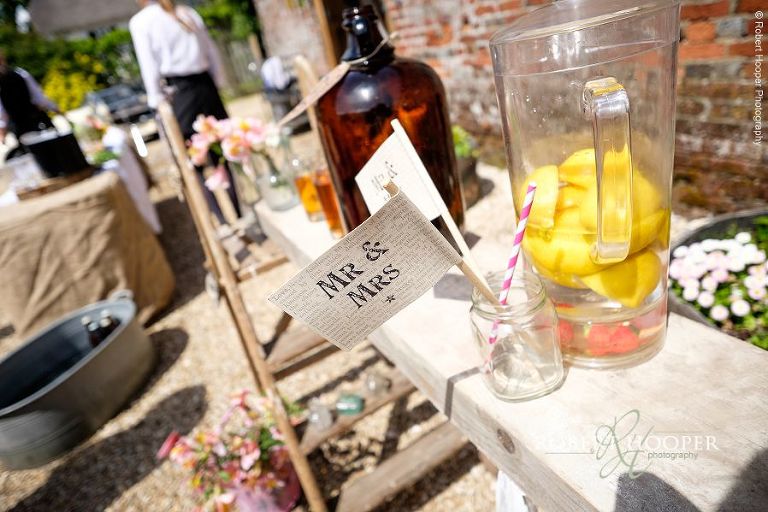 Mr and Mrs flag in jar on wooden table at village picnic themed wedding reception in the garden and marquee at The Three Tuns Bransgore Dorset