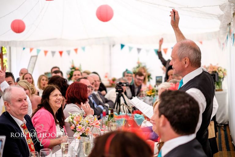 Father of the bride gives his speech at wedding breakfast in marquee at The Three Tuns Bransgore Dorset