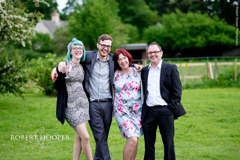 Wedding couple's family posing for family picture at wedding reception in the gardens of The Three Tuns Bransgore Dorset