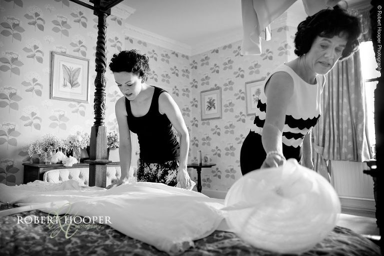 Bride preparing to put wedding dress on for her wedding ceremony at Eastwell Manor Ashford Kent