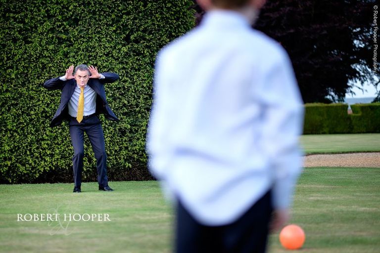 Wedding guest playing games with the children in the grounds of Eastwell Manor, Ashford in Kent