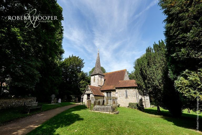 Outside view of St. Peter & St. Paul's church in Chaldon taken by professional wedding photographer on couple's wedding day