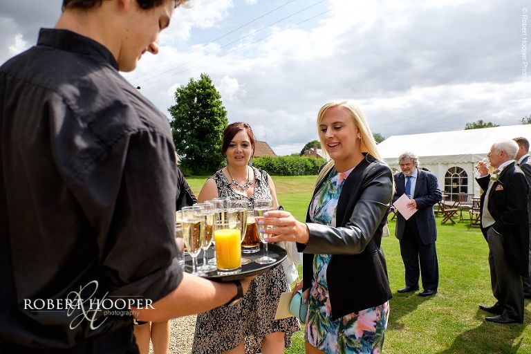 Guests being served drinks at wedding reception at Brewerstreet Farmhouse in Bletchingly Surrey