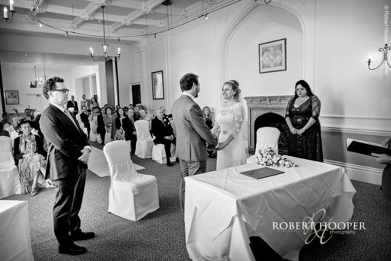 Bride and groom saying their wedding vows at civil ceremony at Horsley Towers Surrey