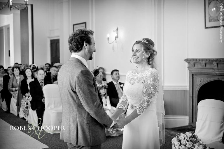Bride and groom exchange vows during their civil wedding ceremony at Horsley Towers in Surrey