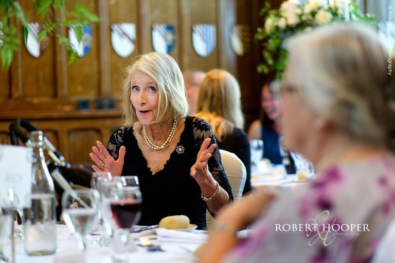 Wedding guest seated for wedding breakfast in the Great Hall at Horsley Towers Surrey