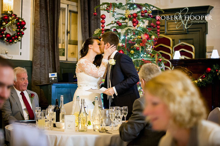 Newlyweds kiss after groom's speech at their wedding breakfast at The Rooms at Browns London