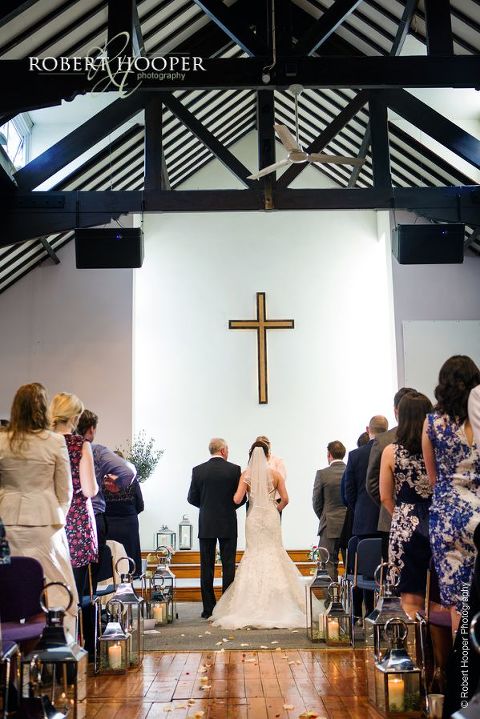 Bride standing at the alter with her dad before her marriage at Bookham Baptist Church in Surrey