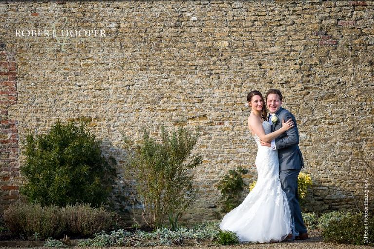 Bride and groom together in the walled garden at Loseley Park in Surrey on their wedding day