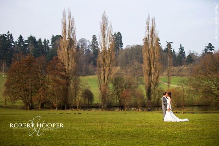 Bride and groom in the landscape at Loseley Park Surrey on their March wedding day