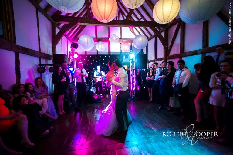 Bride and groom's first dance as married couple in the Tithe Barn at Loseley Park, Guildford in Surrey