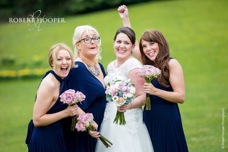 Bride with bridesmaids on wedding day at Chilston Park in Kent