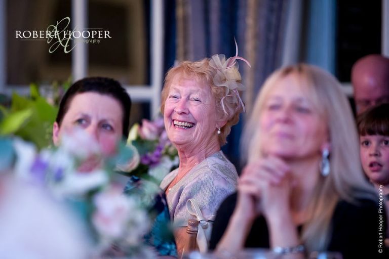 Wedding guests laughing at speeches during wedding breakfast in Culpeppers room at Chilston Park Kent