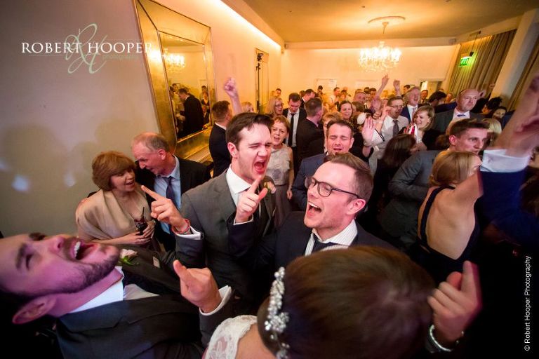 Wedding guests singing and dancing after first dance at wedding at Chilston Park Kent
