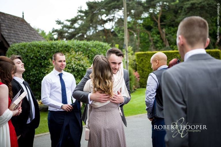 Groom greeting wedding guests to Oaks Farm Barn Croydon Surrey