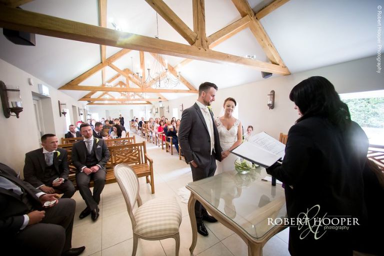 Bride and groom during civil wedding ceremony at Oaks Farm Barn Croydon Surrey