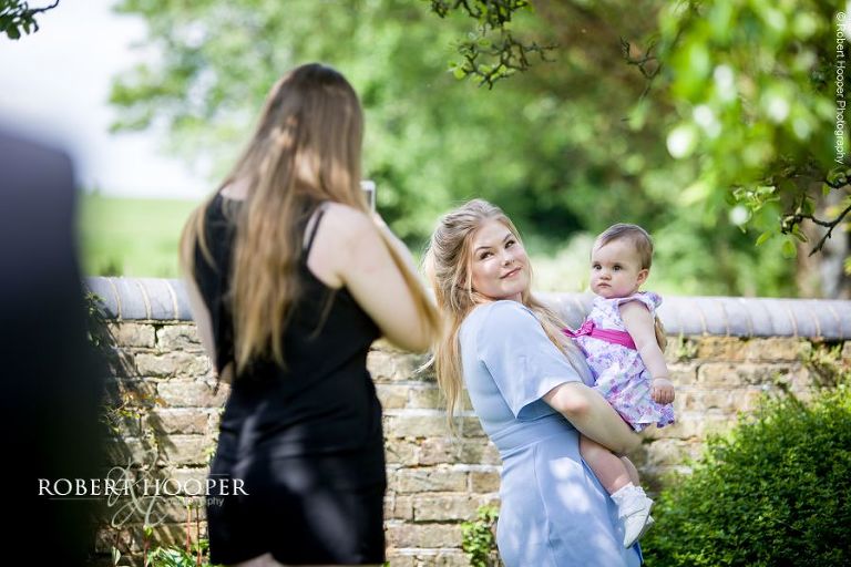 Wedding guests taking photos of each other at Oaks Farm Barn Croydon Surrey